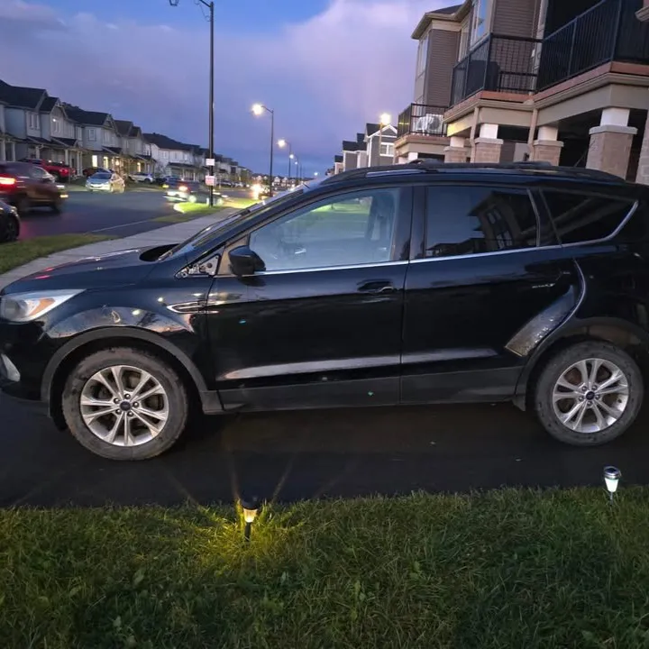 Black SUV with bare doors before the graphics were applied